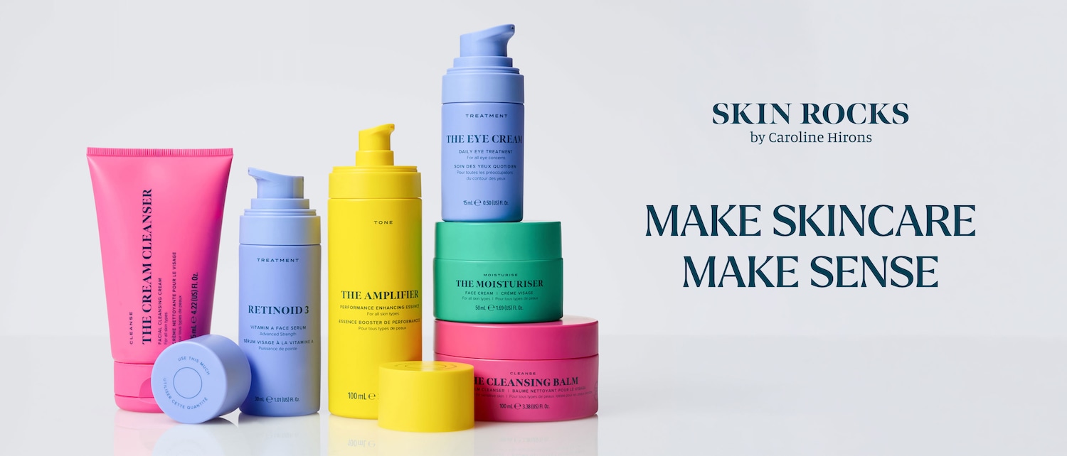 Eine Reihe von Hautpflegeprodukten in leuchtenden Farben, darunter eine pinkfarbene Tube "The Cream Cleanser", eine hellblaue Flasche "Retinoid 3" und eine gelbe Flasche "The Amplifier".
