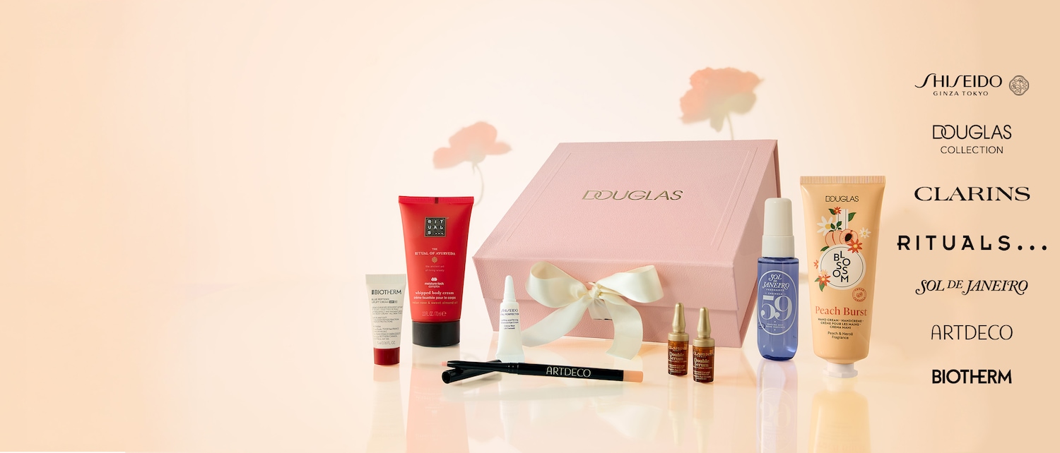 A collection of beauty products from brands like Rituals, Biotherm, and Douglas, neatly arranged with a pink Douglas gift box tied with a white ribbon, perfect for gifting or personal pampering.