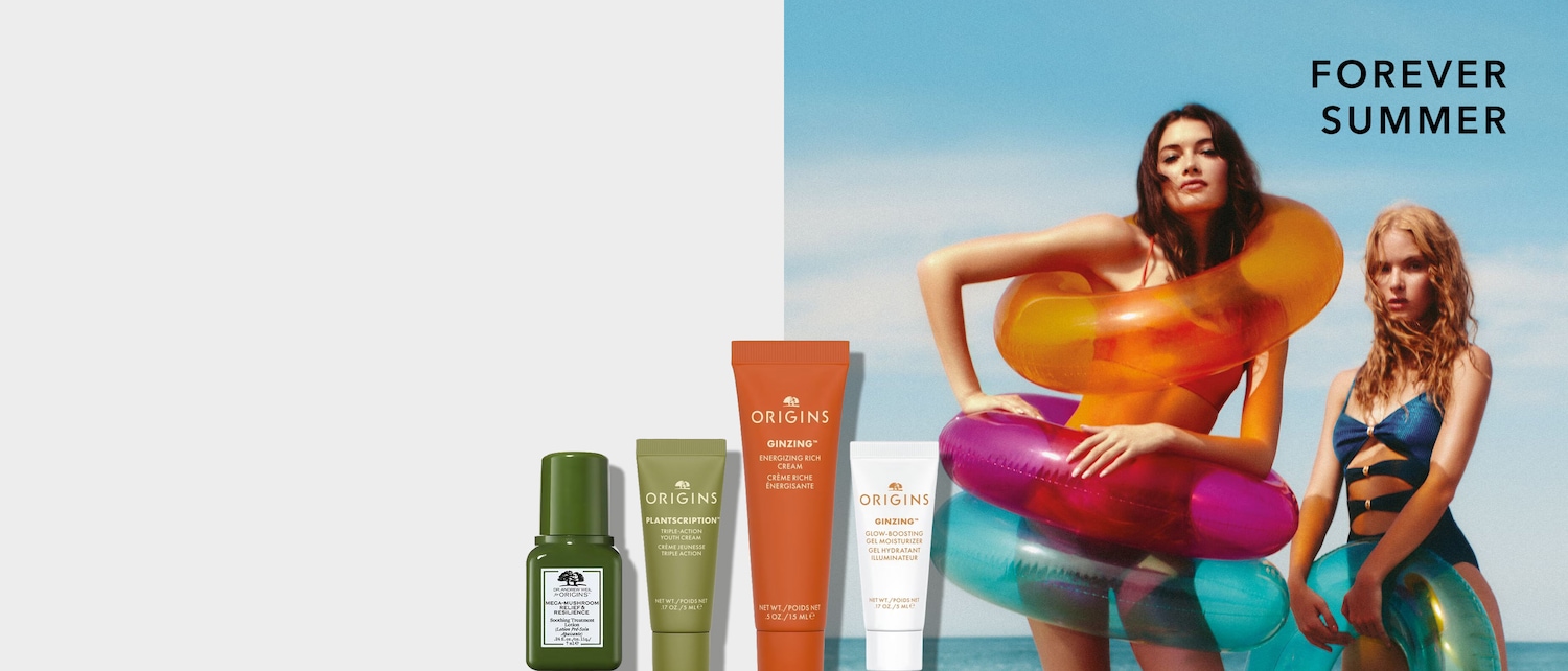 Vier Origins Hautpflegeprodukte, Pipette, eine grüne Tube "Plantscription Youth Cream", eine orangefarbene Tube "Ginzing Energizing Rich Cream" und eine weiße Tube "Ginzing Glow-Boosting Gel Moisturizer".