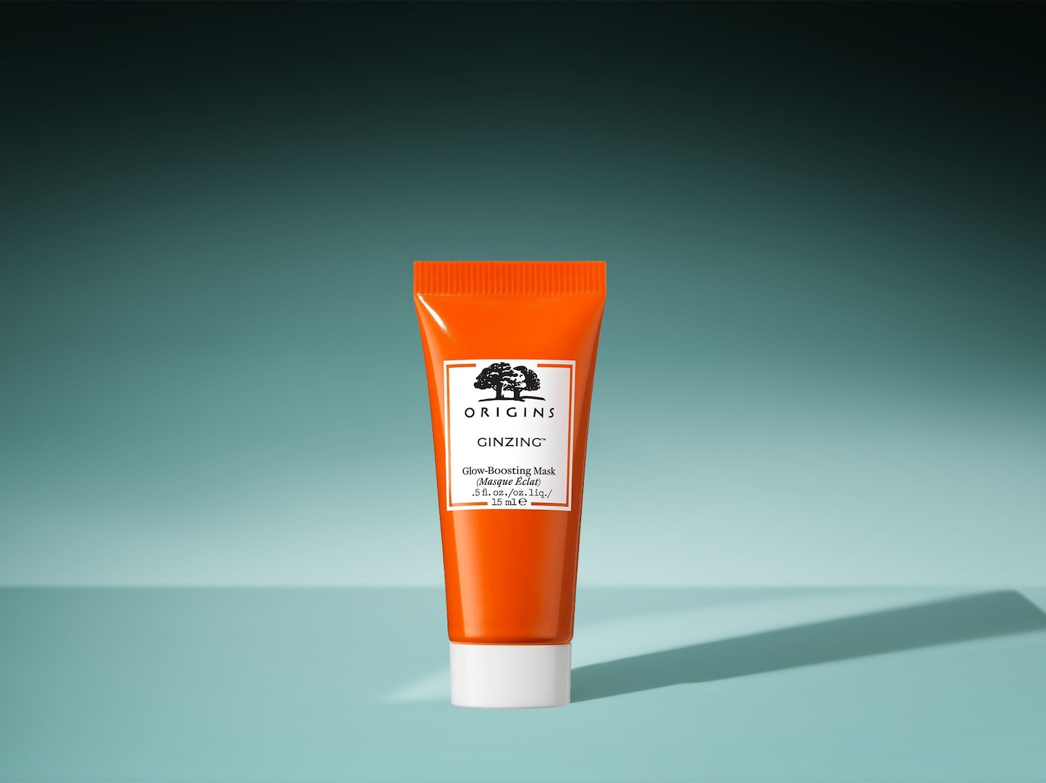 Die orangefarbene Tube Origins Ginzing Glow-Boosting Mask mit weißer Kappe verspricht mit 15 ml eine strahlende Haut.
